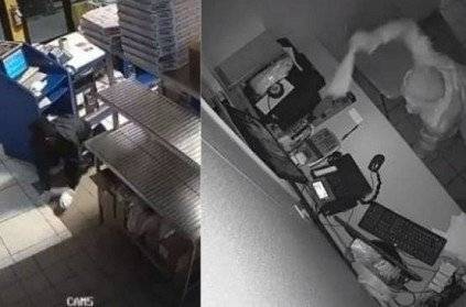 thief caught on CCTV breaking a window, stealing an empty safe